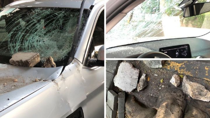 Cae roca del segundo piso del Periférico y rompe parabrisas de un auto (VIDEO)